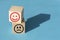 Happy and sad smile faces on wooden blocks on blue background