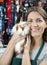 Happy Saleswoman Holding Cute Guinea Pig At Store