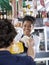 Happy Saleswoman Selling Cheese To Customer At Shop