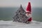 Happy Santa Claus Doll on Christmas time with tree and snow. Blurred outdoor background. Santa Clause and Merry Christmas model fi