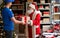 Happy Santa Claus giving parcel gift box to courier, fast christmas delivery.
