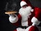 Happy Santa Claus is seating holding big hot steaming pizza offering, serving, brought us. New year and Xmas fast food
