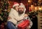 happy santa couple in love. celebrate new year together. xmas presents. family holiday weekend. lovers at decorated tree