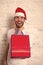 Happy santa man. man in santa hat hold christmas present. delivery christmas gifts. The morning before Xmas. online