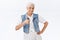 Happy, satisfied charming granny with pleased expression, smiling, showing thumbs-up delighted, rate good choice, give