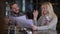 Happy satisfied man and woman giving high-five planning business strategy sitting at bar counter indoors. Portrait of