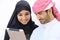 Happy saudi arab couple looking a tablet together