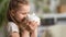 Happy savings. Close-up, little cute girl with white piggy Bank in her hands