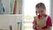 Happy school girl searching book in library