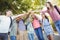 Happy school kids forming hand stack in campus