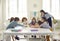 Happy school teacher and little children having a class and learning new letters