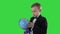 Happy schoolboy in a formal suit studying a globe on a Green Screen, Chroma Key.