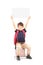 Happy schoolboy holding a panel above his head, seated on a pile