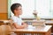 Happy schoolboys sitting at desk, classroom