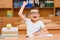 Happy schoolboys sitting at desk, classroom