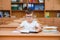 Happy schoolboys sitting at desk, classroom