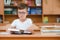 Happy schoolboys sitting at desk, classroom