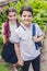 happy schoolchildren with backpacks looking at camera