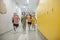 Happy schoolchildren running in the school corridor after lessons