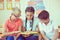 Happy schoolchildren studing in classroom during lesson at primary international school