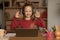 Happy Schoolgirl Gesturing OK To Laptop Making Video Call Indoor