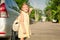 Happy schoolgirl standing on the road