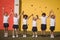 Happy schoolgirls standing with hand in hand