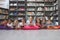 Happy schoolteacher lying with his school kids in a library