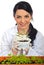 Happy scientist holding new cucumber plants