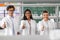 happy scientists showing thumbs up in laboratory