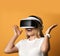 Happy screaming blonde woman is excited with virtual reality she explores using vr glasses. Woman in cyber space.