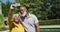 Happy senior african american couple using smartphone taking selfie by swimming pool in sunny garden