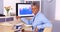 Happy senior african businesswoman sitting at desk