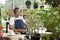 Happy senior asian retired man listening to music  and enjoying  leisure activity in garden at home