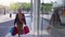 Happy senior attractive lady with shopping bags walking in the street smiling. Entering in a mall.