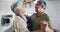 Happy senior biracial couple dancing in kitchen