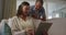 Happy senior caucasian couple in living room using tablet and talking