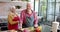 Happy senior caucasian couple wearing aprons cooking dinner in kitchen at home, slow motion