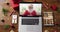 Happy senior caucasian santa on video call on laptop, with smartphone, tablet christmas decorations