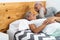 Happy senior couple in bed - Hipster mature people having funny bed time together