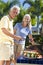 Happy Senior Couple Cooking on A Summer Barbecue