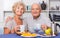 Happy senior couple enjoying conversation over cup of coffee