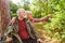 Happy senior couple exploring forest on summer vacation