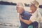 Happy senior couple have fun and enjoy outdoor leisure activity at the beach. the man carry the woman on his back to enjoy