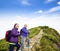 Happy senior couple hiking on the mountain