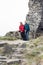 Happy senior couple hiking on rocky terrain