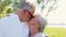 Happy senior couple kissing at summer park
