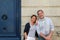 Happy senior couple leaning on city building wall