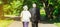 Happy senior couple love story. Old couple is walking in the green park. Grandmother and grandfather laughing. Elderly people