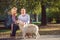 Happy Senior couple outdoors with dog enjoying